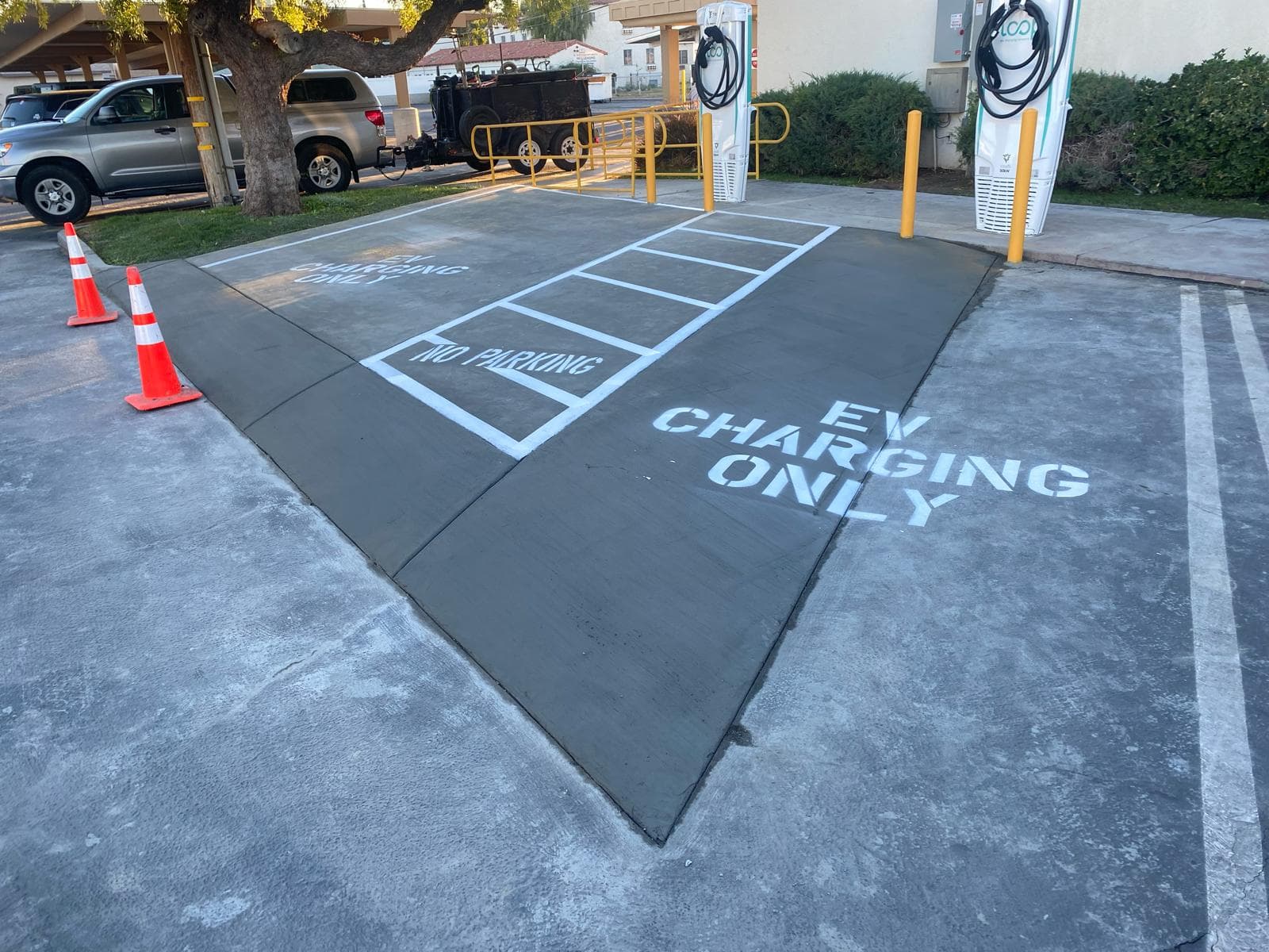 picture of newly installed asphalt in an ev charging area in a commercial parking lot